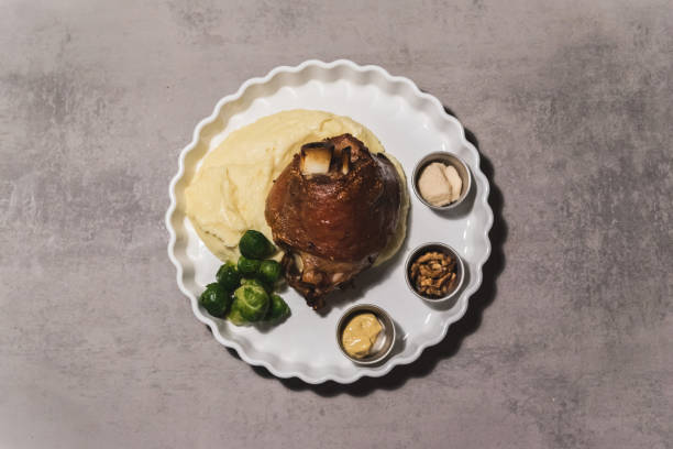 istock Baked pork with potatos and green vegetables 1065644682