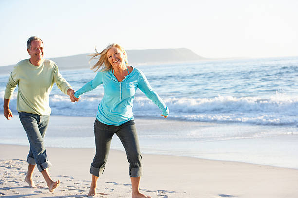 istock A couple in jeans walking along the shore 106564539