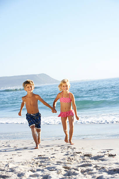 istock Children running along sandy beach 106564658