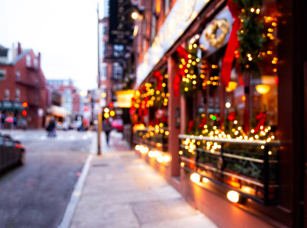 city street with Christmas illuminations blurred background. Christmas lights and Christmas decorations on the street outdoor christmas decorations at christmas town usa stock pictures, royalty-free photos & images