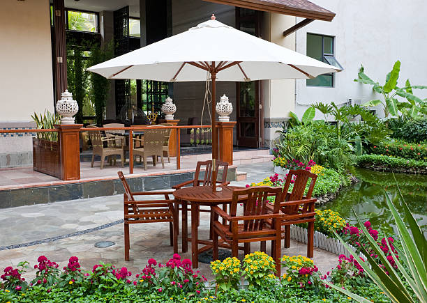 Patio with table, chairs and many flowers