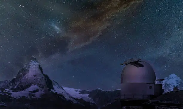 Switzerland, Zermatt. The dome of the astronomic observatory on the Cornergrat, facing  the Matterhorn, under a starry sky with the Milky Way.