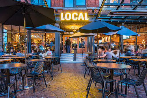 People relax on the patio of a gastropub in Gastown, downtown Vancouver, British Columbia, Canada in the evening.