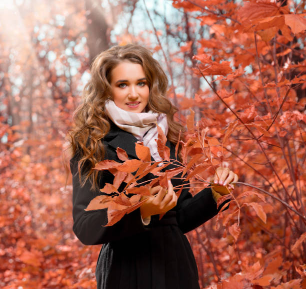 istock Girl in autumn forest 1065683752