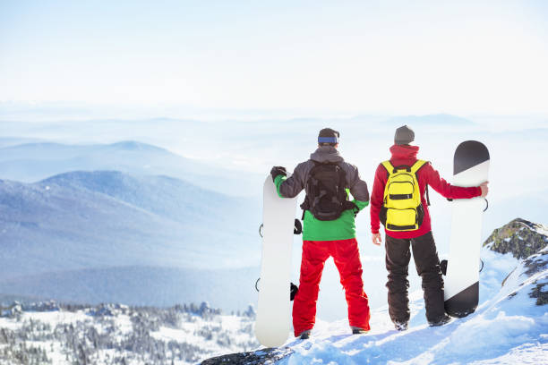 istock Two snowboarders mountain top view point 1065685492