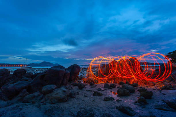 istock Spark fire swirl from steel wool over the rocks 1065690572