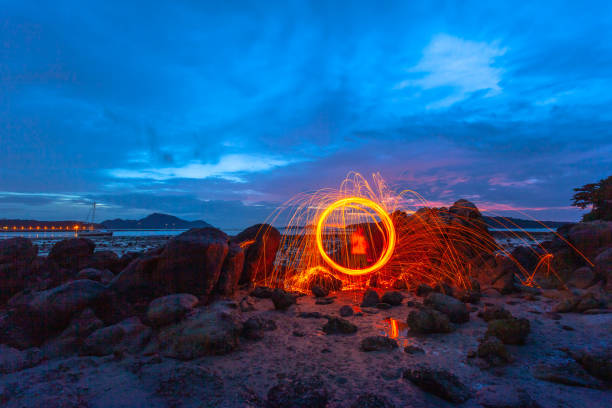 istock Spark fire swirl from steel wool over the rocks 1065690582