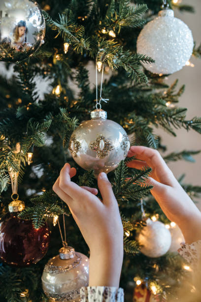 istock Young girl decorating Christmas tree 1065692294