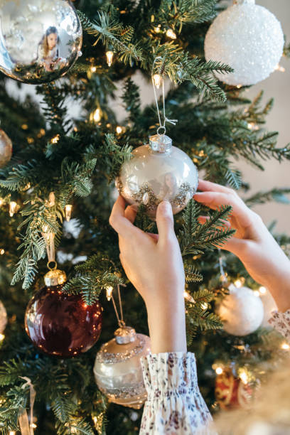 istock Young girl decorating Christmas tree 1065692316