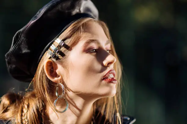 Photo of Fashionable model wearing leather beret participating in photo session