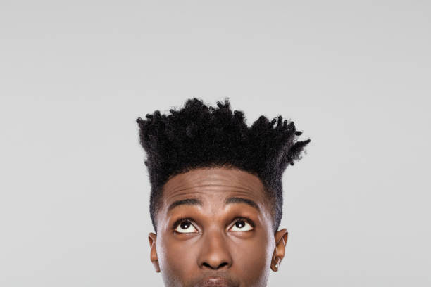 istock Half face of young african guy looking up 1065696922