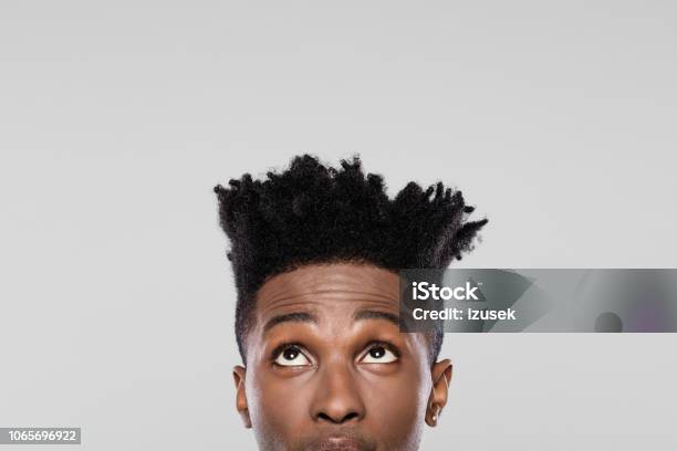 Half Face Of Young African Guy Looking Up Stock Photo - Download Image Now - Halved, Human Face, Looking Up