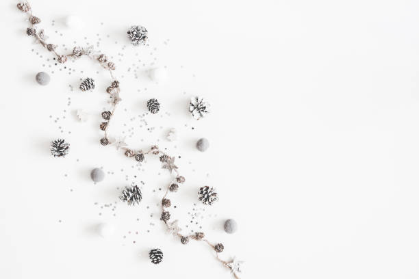 istock Christmas composition. Christmas white and silver decorations, pine cones on white background. Flat lay, top view, copy space 1065696926
