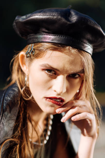istock Trendy young model biting her lip while posing for the photographer 1065697288