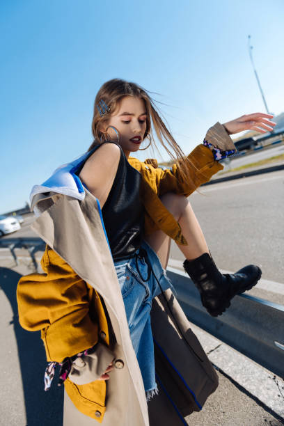 istock Dark-haired skinny model posing on the bridge on windy day 1065697308