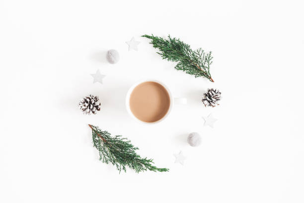 istock Christmas composition. Cup of coffee, fir tree branches, pine cones on white background. Flat lay, top view, copy space 1065697492