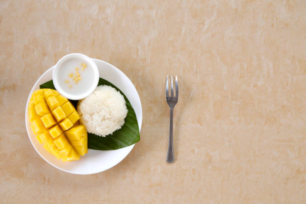istock Thai sweet sticky rice with mango on yellow wooden 1065706748