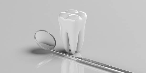 istock Dentist mirror and a tooth model on grey background, copy space. 3d illustration 1065706768