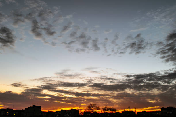 istock Sky with clouds at sunset over the evening city. Building Silhouettes 1065720104
