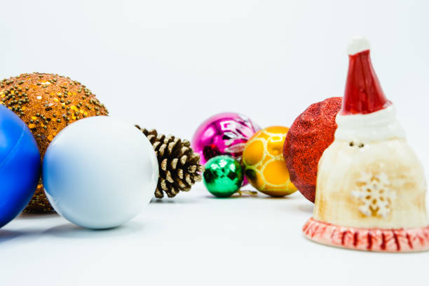 istock Colorful christmas tree balls on white background with Santa Claus statuette. 1065720638