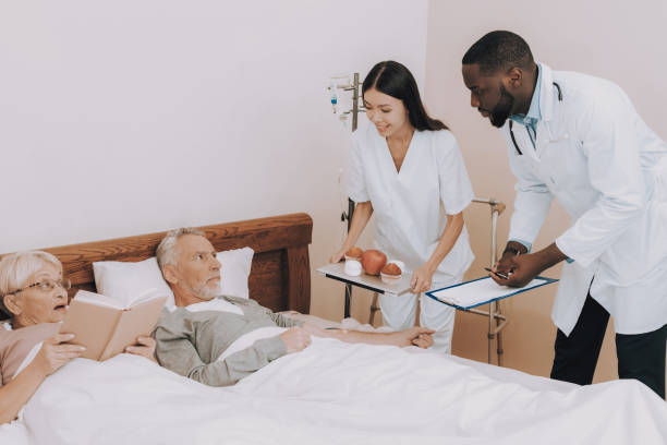 istock Nurse Bring Apple and Muffins to Bed.Man Dripping. 1065726312