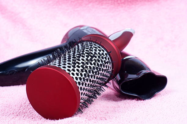 istock red round comb and hairdryer on rose background 106572739
