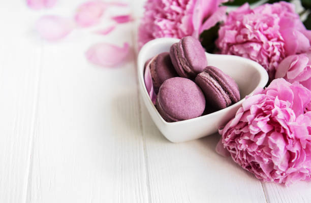 istock Pink peony flowers with macarons 1065727928