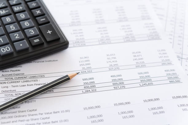 accounting spread sheets balance sheet and calculator on accountant's desk. Accounting , accounts concept. above view. banking document stock pictures, royalty-free photos & images