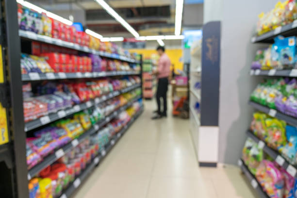 istock Abstract blurred supermarket aisle with colorful shelves and unrecognizable customers as background 1065735528