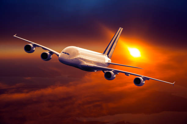 istock Civil wide body plane in flight. Sunset time. 1065736590