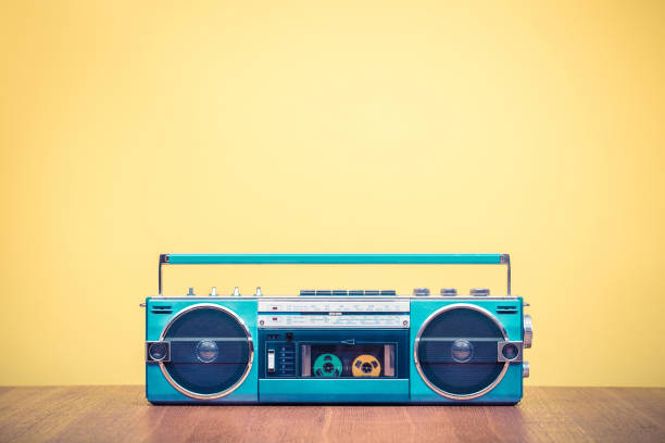 Retro outdated portable stereo mint green radio cassette recorder from 80s front yellow background. Vintage old style filtered photo Retro outdated portable stereo mint green radio cassette recorder from 80s front yellow background. Vintage old style filtered photo rock music photos stock pictures, royalty-free photos & images