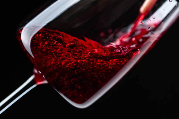 istock Red wine being poured into wineglass. 1065738184