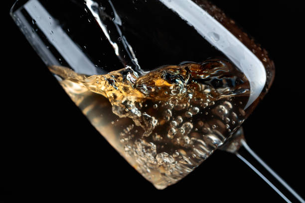istock White wine being poured into wine glass. 1065738194