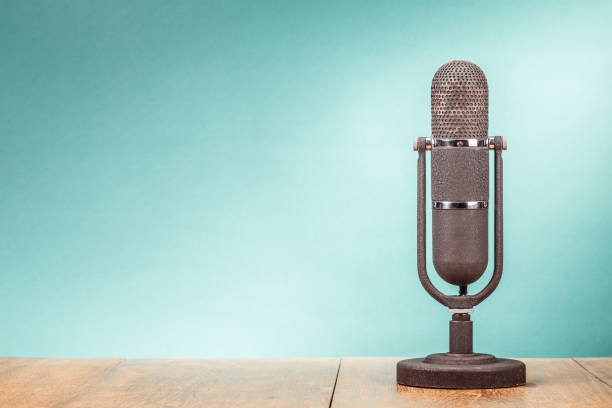 Retro big microphone from 50s on table front gradient mint green background. Vintage old style filtered photo Retro big microphone from 50s on table front gradient mint green background. Vintage old style filtered photo commentator photos stock pictures, royalty-free photos & images