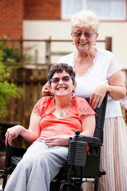 istock disabled woman with carer in garden 106574082