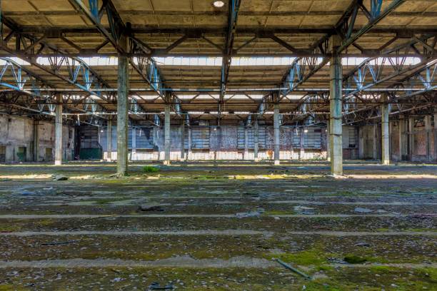 istock Abandoned large factory industrial interior. 1065743284
