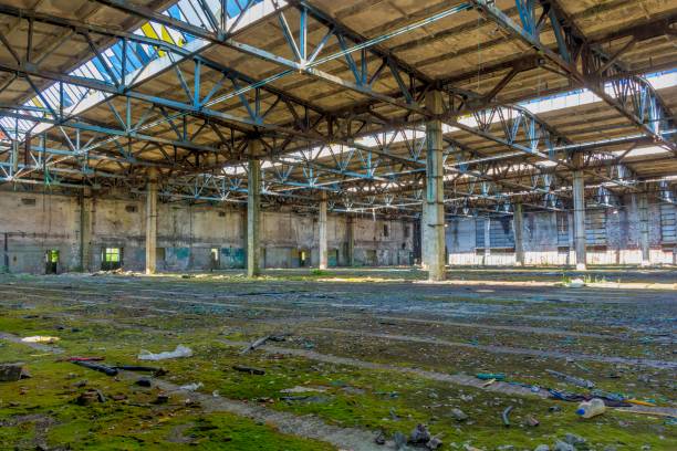 istock Abandoned large factory industrial interior. 1065743682
