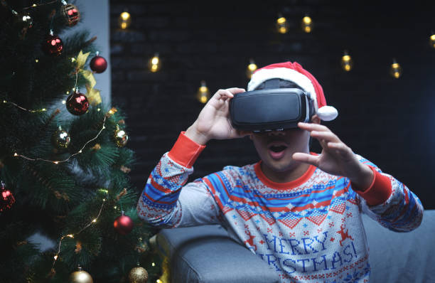 istock Asian Man With Christmas Costume Playing Virtual Reality Sitting Beside Christmas Tree 1065743810