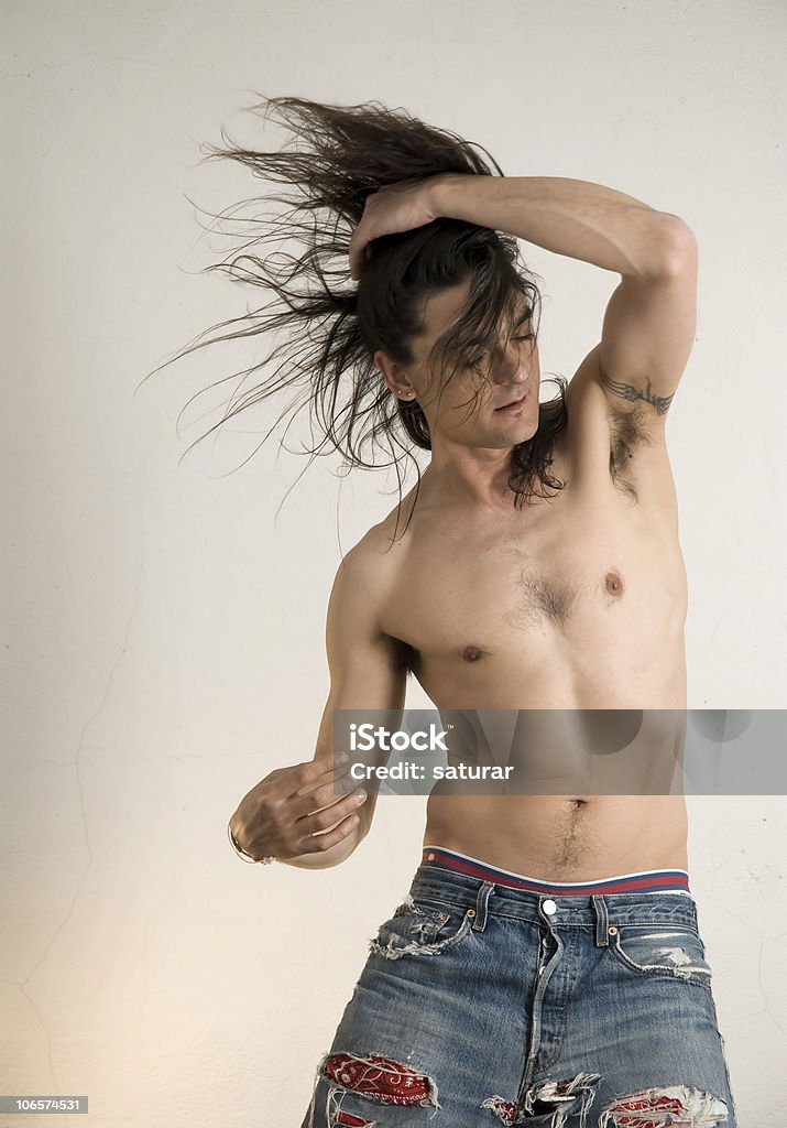 moving man without t-shirt dancing with energy. He could be holding a bottle in his hand ;)  Men Stock Photo