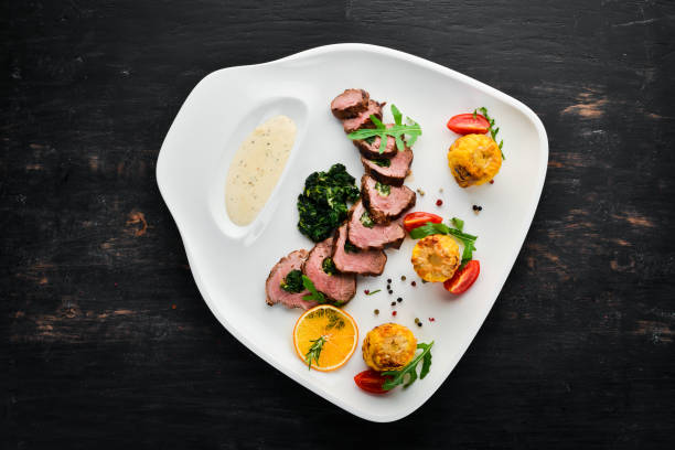 istock Veal steak with spinach and corn. On a wooden background. Top view. Free copy space 1065746300