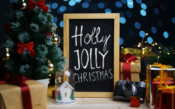 istock Holly Jolly Christmas Typography on Blackboard Between Christmas Decoration 1065746390