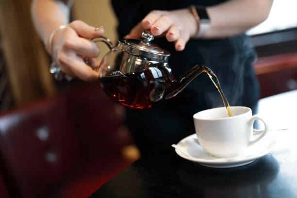 istock Waiter fills cup of tea 1065756078