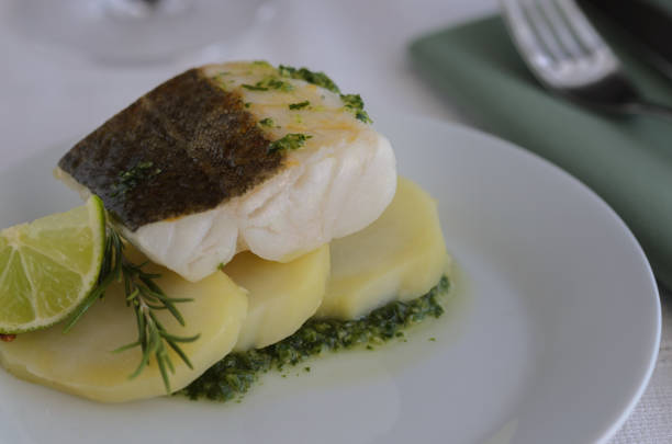 istock Fresh cod fish with potatoes on the pate in the restaurant. This  popular dish called  bacalhau a braga  in  Portugal and Bacalao a la gallega in Spain. 1065757850