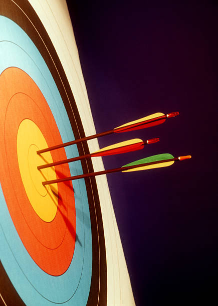 Colorful bulls eye target with three arrows in the center stock photo