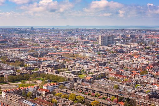 High angle panoramic view of The Hague (Den Haag), skyline with the North Sea and cloudy blue sky, Netherlands