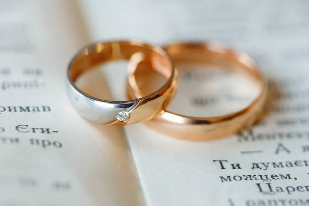 istock Engagement wedding gold rings on a book 1065764528
