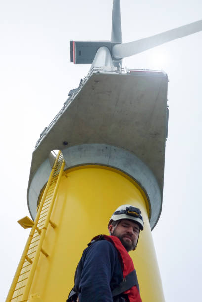 istock Young man technician worker standing under gigantic offshore wind-turbine and took selfie 1065764546