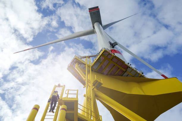 Manual high worker offshore climbing up - down from wind-turbine on ladder