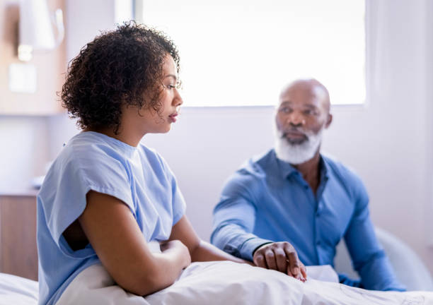 istock Father consoling daughter by holding hands 1065767224