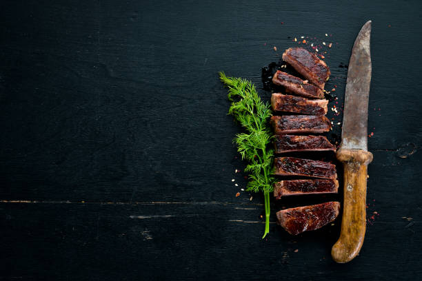 istock Veal steak. On a wooden background. Top view. Free space for your text. 1065767688